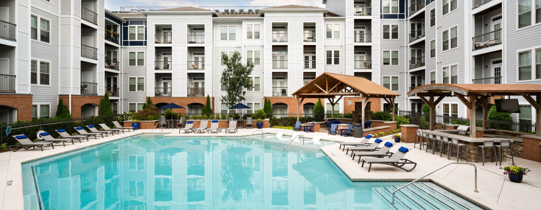Pool with sun shelf and lounge seating at Avanti Brookhaven pet-friendly apartments in Brookhaven, GA.